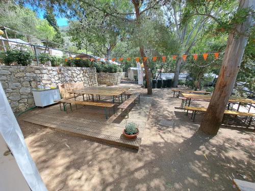 a patio with picnic tables and a string of flags at Elba Travels in Capoliveri