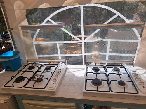a kitchen with two stove tops in front of a window at Elba Travels in Capoliveri