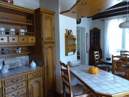 a kitchen with a table with a pumpkin on it at La petite colline du Cros, villa à louer in Saint-Pierre-de-Chignac