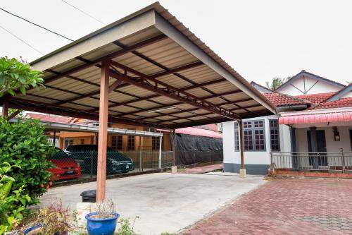 awning over a patio of a house at D'BALI HOMESTAY - Private Swimming Pool, NETFLIX, Internet Wifi ,Cuckoo, Internet Wifi , Dryer, Washing Machine, Aircond Setiap Bilik & Ruang Tamu in Pasir Puteh