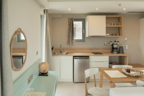 a kitchen and dining room with a table and chairs at Callisto Seaside Homes & Suites in Marathopolis