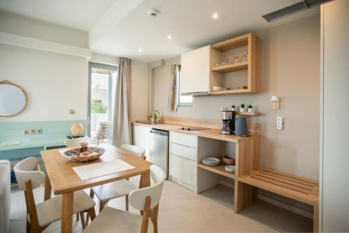 a kitchen and dining room with a table and chairs at Callisto Seaside Homes & Suites in Marathopolis