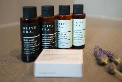 three bottles of essential oils sitting next to a box at Callisto Seaside Homes & Suites in Marathopolis