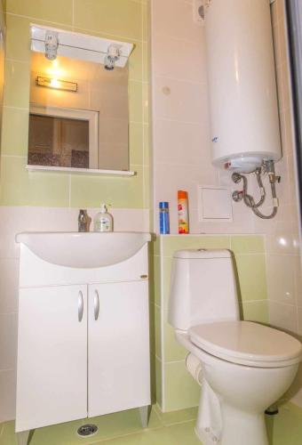 a bathroom with a white sink and a toilet at Tedi in Kranevo