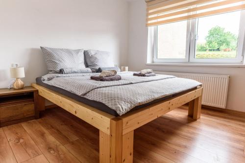 a bed with two towels on it in a bedroom at Apartmány Slavíkov - Country Suite in Horní Radechová
