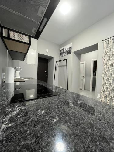a kitchen with a black counter top in a room at St Benedict Apartments in Lviv