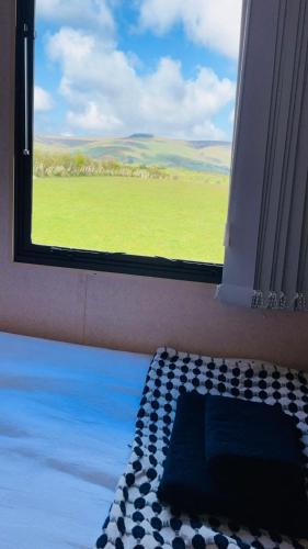 a window in a room with a view of a field at Mobile Holiday Home in Cushendall