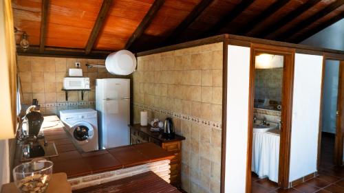 a kitchen with a refrigerator and a sink at Rural Tarifa Villa María in Tarifa