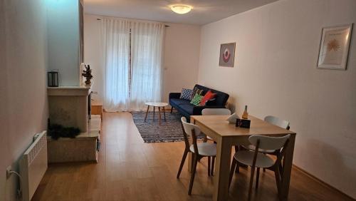 a living room with a table and a couch at Aparthotel Raikov Ski Lodge in Pamporovo