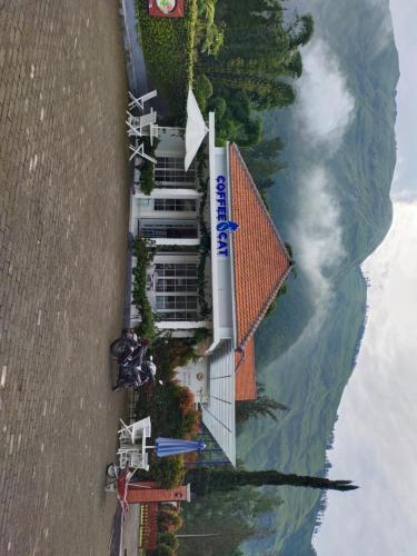 an aerial view of a building next to the water at Harmony Resto&Homestay in Lambangkuning