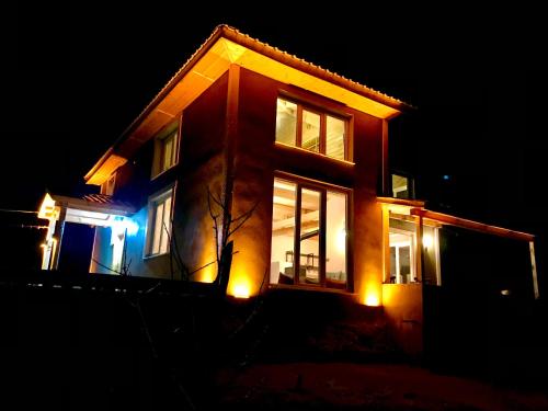 a house with lights on the side of it at night at Bytemur in Çamlıhemşin