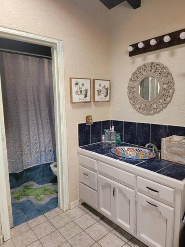 a bathroom with a sink and a toilet and a mirror at Casa Grace en Playa Del Sol-15 in San Antonio del Mar