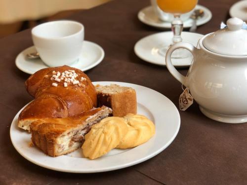a plate of bread and pastries on a table at Hotel Da Raffaele in Ischia