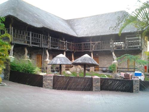 a building with umbrellas in front of it at Jabula Kruger Safari Lodge in Marloth Park