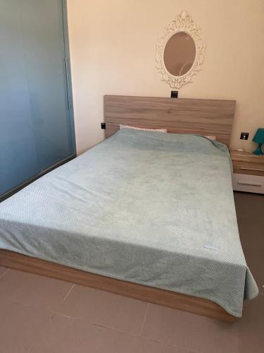 a bedroom with a large bed with a mirror on the wall at Sea view Villa Sotiritsa in Velika