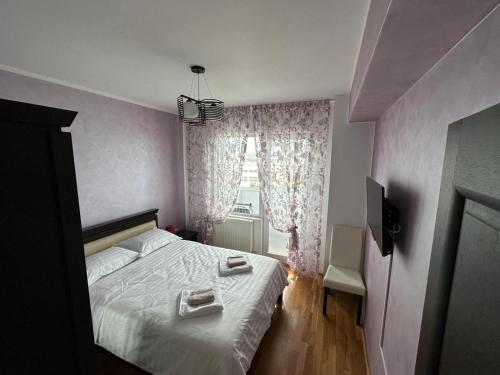 a bedroom with a bed with two towels on it at Luxury Nordic 46 Apartment in Suceava