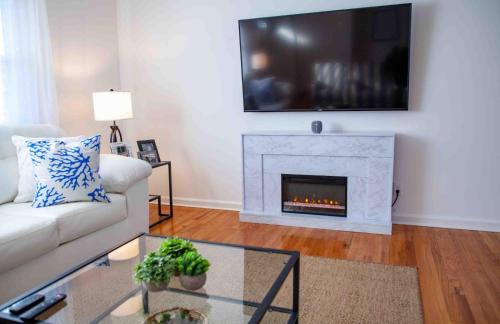 a living room with a couch and a fireplace at Cozy 3 Bedroom Home in Reynoldsburg