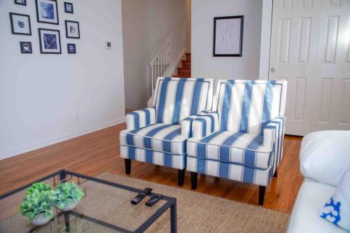 two blue and white striped chairs in a living room at Cozy 3 Bedroom Home in Reynoldsburg