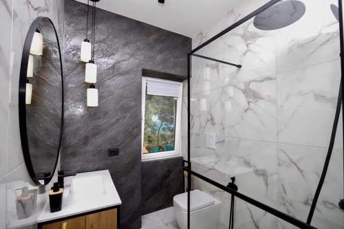 a bathroom with a toilet and a sink and a mirror at ML Apartments in Vieste