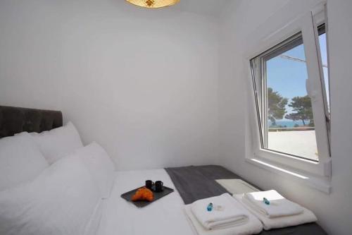 a room with a bed with two towels and a window at ML Apartments in Vieste