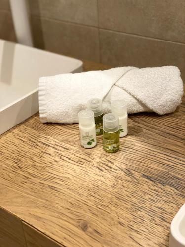 a bathroom with a towel and four glass jars on a counter at Apartamento Moderno Centro Bilbao in Bilbao