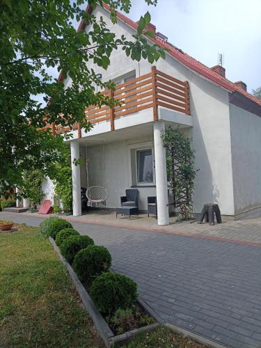 a house with a balcony and a patio at DOM w JESIONACH Brajniki - działka 1 HEKTAR in Jedwabno