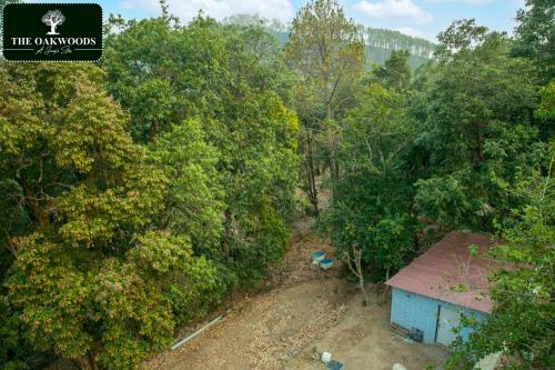 an overhead view of a dirt road in a forest at The Oakwoods in Bhowāli