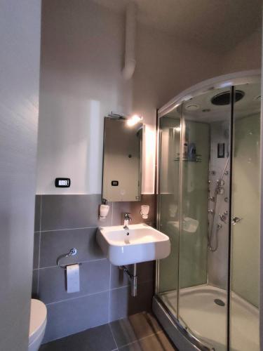 a bathroom with a sink and a shower at Camere D'artista in Enna