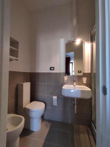 a bathroom with a toilet and a sink at Camere D'artista in Enna