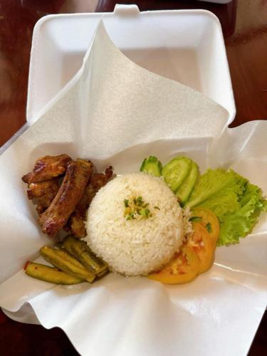 a white plate of food with rice and vegetables at Ditar Guest House D in Battambang