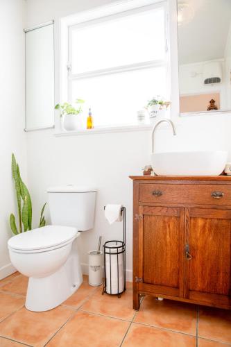 a bathroom with a toilet and a sink at Grace Road Cottage in Tauranga