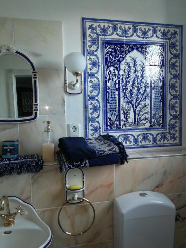 a bathroom with a toilet and a sink and a mirror at Gästehaus Fuchsröhre in Welcherath