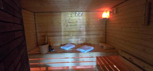a wooden sauna with two towels sitting in it at Kaszuby wczasy u Danusi sauna i bania in Lipusz