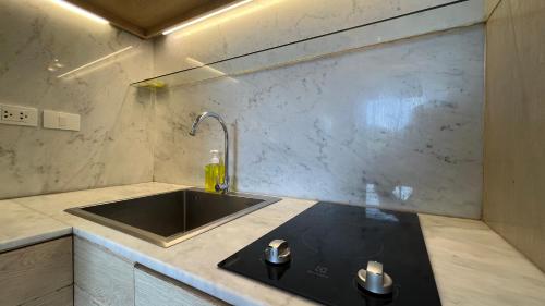 a kitchen with a sink and a counter top at Rocco Apartments a Cosy Luxury Stay Holiday Home in Krabi in Ao Nang Beach