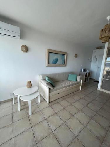 un salon avec un canapé et une table dans l'établissement studio climatisé les pieds dans l'eau, à Six-Fours-les-Plages