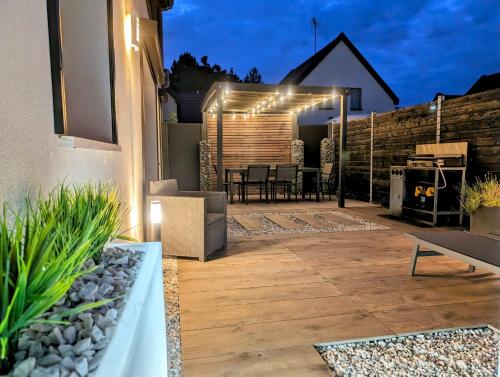 a backyard patio with a grill and lights at La Chataigneraie in Châtenois