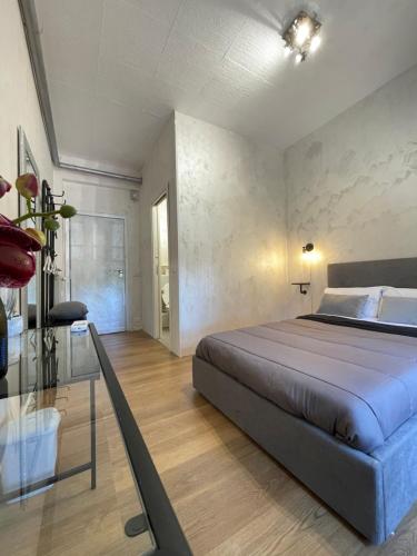 a bedroom with a large bed and a glass table at Guest House Romoli in Rome