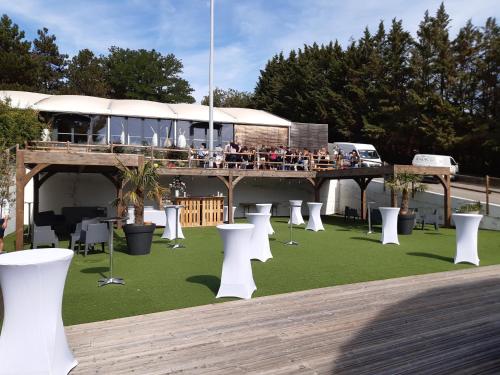 un groupe de personnes assises dans un restaurant sur une jetée dans l'établissement Domaine de Chantesse, Location de salles et Hebergements, seminaires , accueil de groupes, à Les Veyrières