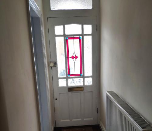 a white door with a stained glass window on it at Number 9 in Hunstanton