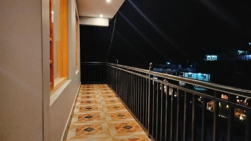 a balcony with a view of the city at night at Kavyansh Forest Valley in Dalhousie