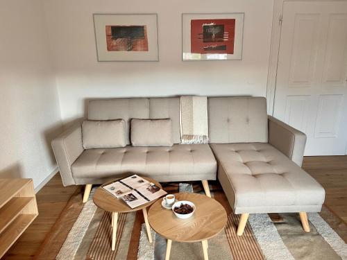 a living room with a couch and a coffee table at Bäckerhaus - Wohnung mit Pool und Garten in Gmunden