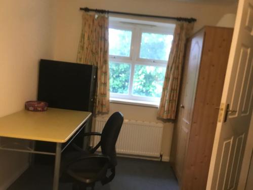 a room with a desk and a chair and a window at 31 Stonelea court in Meanwood