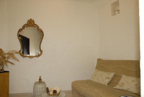 a living room with a couch and a mirror at Joli havre de paix in Vence