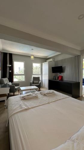 a large bedroom with a large bed and a living room at Kelebek Apartments in Kalkan