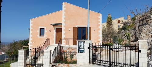 a house with a staircase in front of a building at Summer Villa with sea view,6 min drive from airport, near Seitan Limania beach in Khordhákion