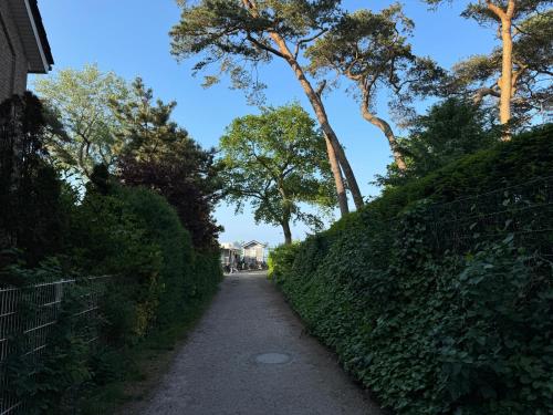a path with trees on the side of a hill at Ocean Escape - Teil der HolidayEscapes Kollektion in Timmendorfer Strand