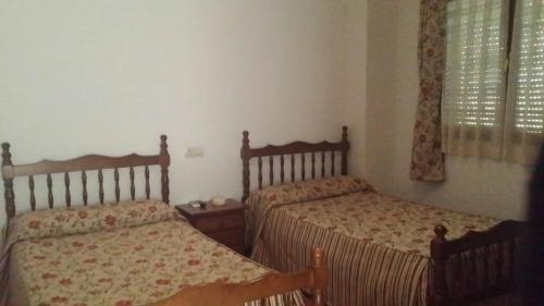 En eller flere senge i et værelse på Pensión El Botijo