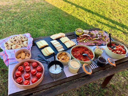 a picnic table with cheese and other food on it at Le Poutic gîte et maison d'hôtes in Créon-dʼArmagnac
