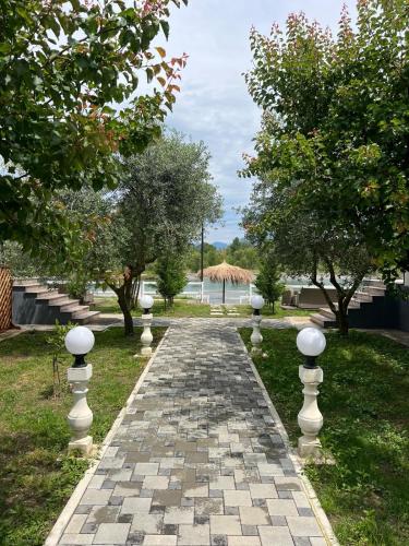 a stone pathway with white spheres on it at Villa Teverde in Shkodër