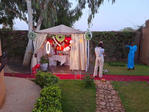 a couple of people standing in front of a tent at Hôtel La Belle Etoile & SPA in Saly Portudal
